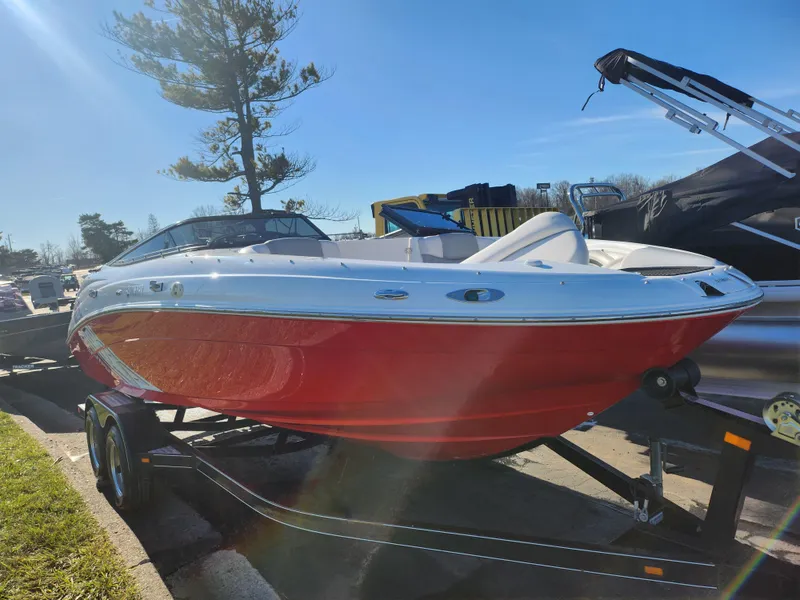 Slide: The Image of 2008 Yamaha Boats 212SS in red on trailer, parked outdoors. - 10