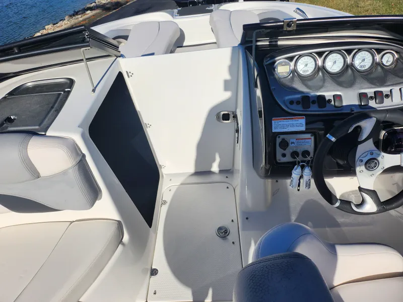 Slide: The Image of 2008 Yamaha Boats 212SS cockpit with steering wheel and dashboard gauges. - 13