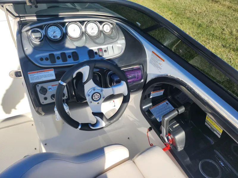 Slide: The Image of 2008 Yamaha Boats 212SS dashboard with steering wheel and control panel. - 14