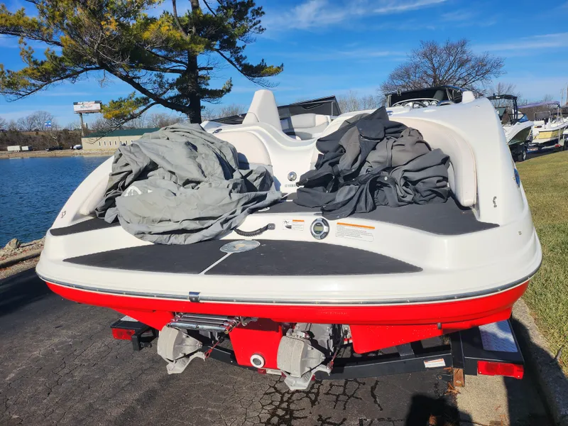 Slide: The Image of 2008 Yamaha Boats 212SS on trailer, red and white, near a lake. - 2