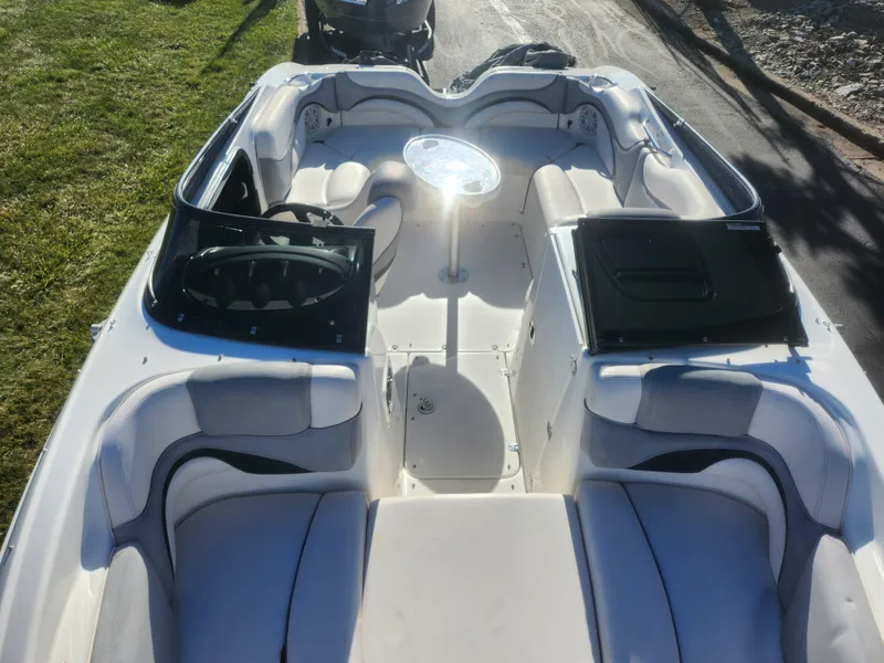 Slide: The Image of 2008 Yamaha Boats 212SS interior with seating and steering wheel, parked on a sunny day. - 22