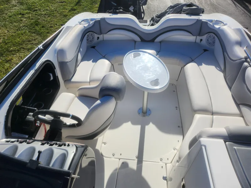 Slide: The Image of 2008 Yamaha Boats 212SS interior with seating and table, featuring a sleek design. - 23