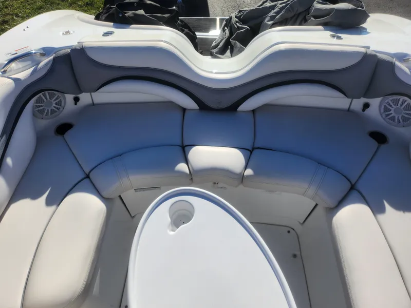 Slide: The Image of 2008 Yamaha Boats 212SS interior with white cushioned seating and built-in speakers. - 24