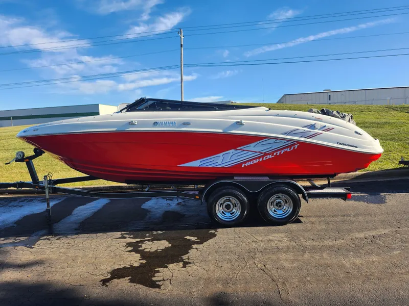 Slide: The Image of 2008 Yamaha Boats 212SS, red and white, on trailer, parked outdoors. - 4