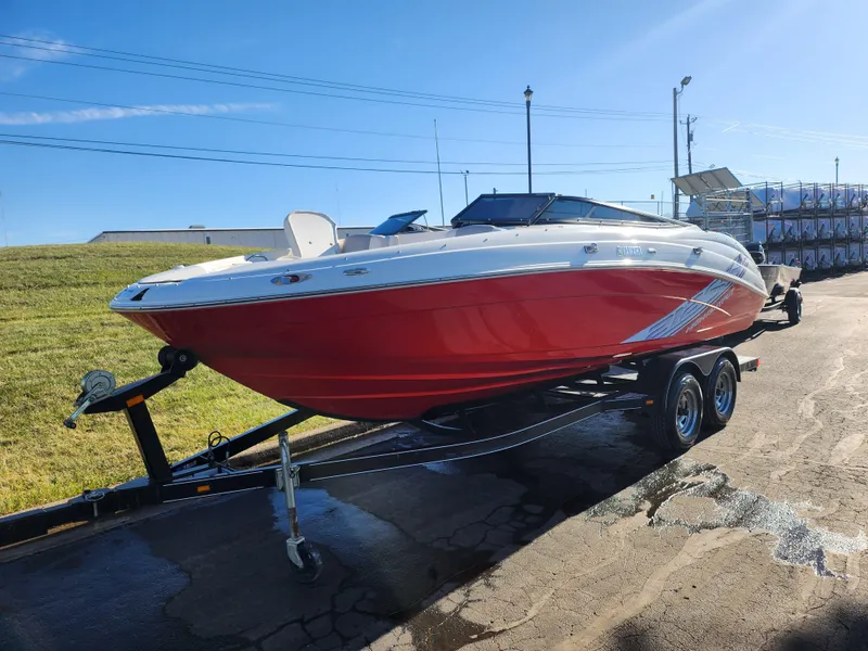 Slide: The Image of 2008 Yamaha Boats 212SS in red on trailer, parked outdoors under clear sky. - 5