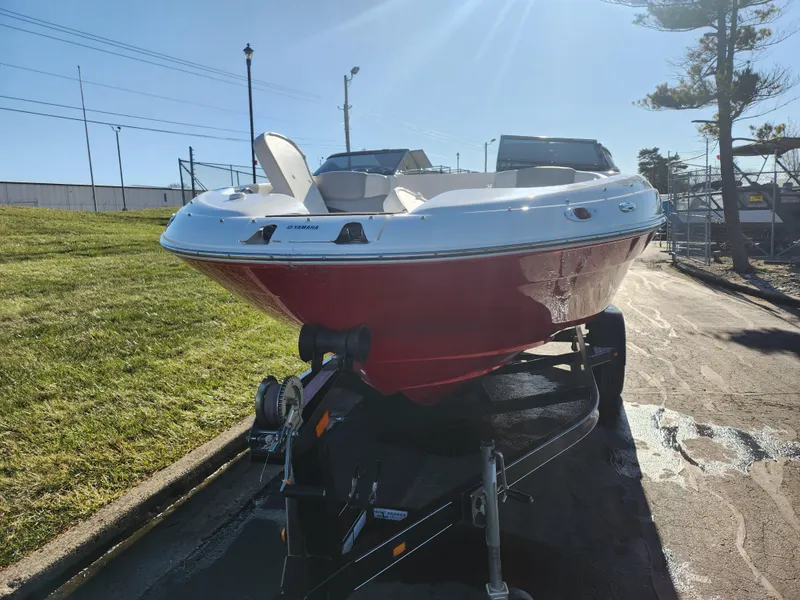 Slide: The Image of 2008 Yamaha Boats 212SS on trailer, red hull, parked outdoors in sunlight. - 6