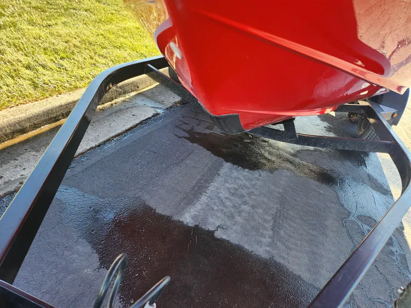 Slide: The Image of Red 2008 Yamaha Boats 212SS on trailer, wet pavement beneath. - 7