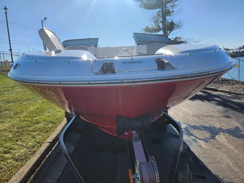 Slide: The Image of 2008 Yamaha Boats 212SS in red on trailer, parked near water. - 8