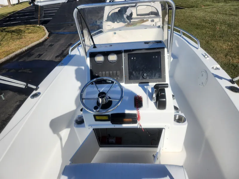 Slide: The Image of 2008 Sea King 180CC boat console with steering wheel and navigation controls. - 10