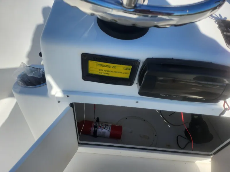 Slide: The Image of 2008 Sea King 180CC boat console with steering wheel and storage compartment. - 11