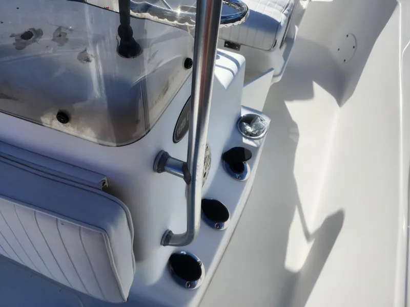 Slide: The Image of Interior view of 2008 Sea King 180CC boat, featuring white seating and console details. - 19