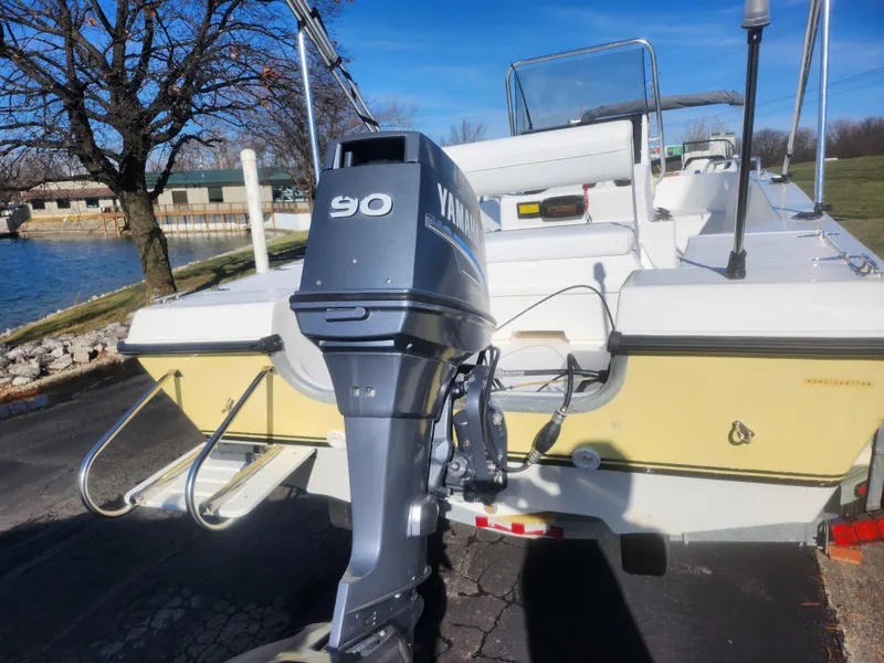 Slide: The Image of 2008 Sea King 180CC boat with Yamaha 90 outboard motor, docked near a lake. - 3