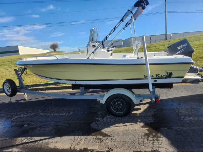 Slide: The Image of 2008 Sea King 180CC boat on trailer with Yamaha motor, parked outdoors. - 5