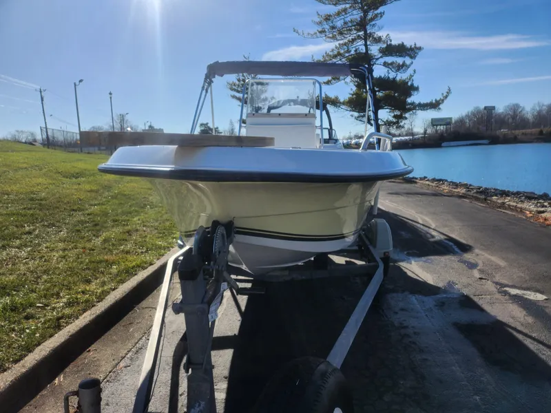 Slide: The Image of 2008 Sea King 180CC boat on trailer by a lakeside under clear blue sky. - 7