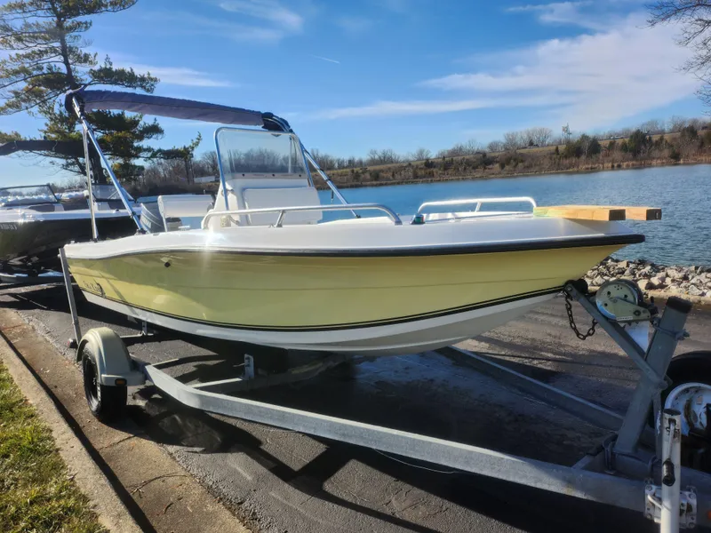 Slide: The Image of 2008 Sea King 180CC boat on trailer by a lake under clear blue sky. - 9