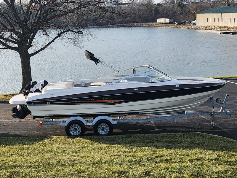 Slide: The Image of 2007 Bayliner 225 boat on trailer by a lake, ready for adventure. - 0
