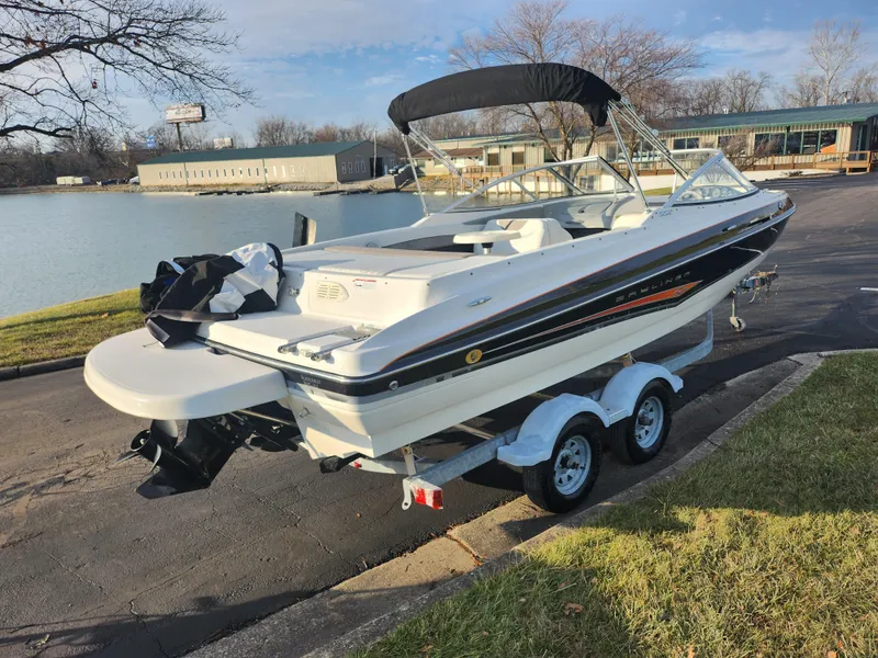 Slide: The Image of 2007 Bayliner 225 boat on trailer by a lakeside. - 1