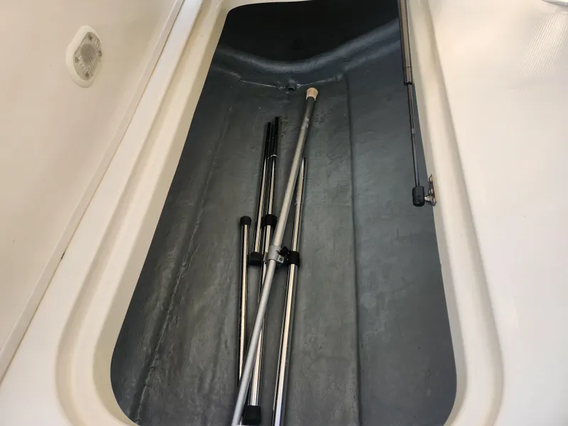 Slide: The Image of Storage compartment of 2007 Bayliner 225 boat with metal poles inside. - 12
