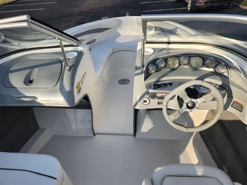 Slide: The Image of 2007 Bayliner 225 boat interior with steering wheel and dashboard gauges. - 13