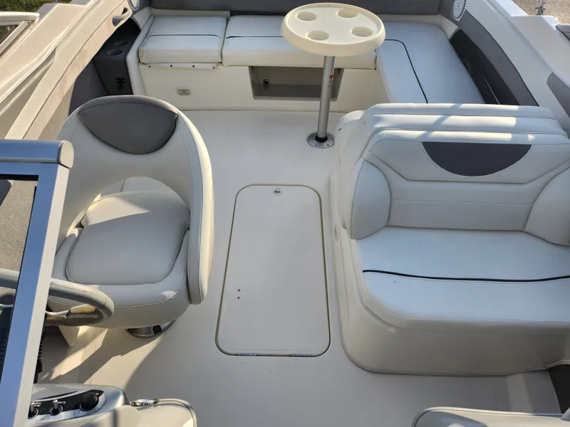 Slide: The Image of 2007 Bayliner 225 boat interior with white seating and table. - 20