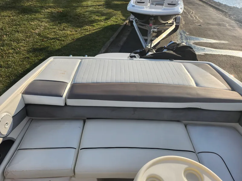 Slide: The Image of 2007 Bayliner 225 boat interior with cushioned seating and trailer. - 22