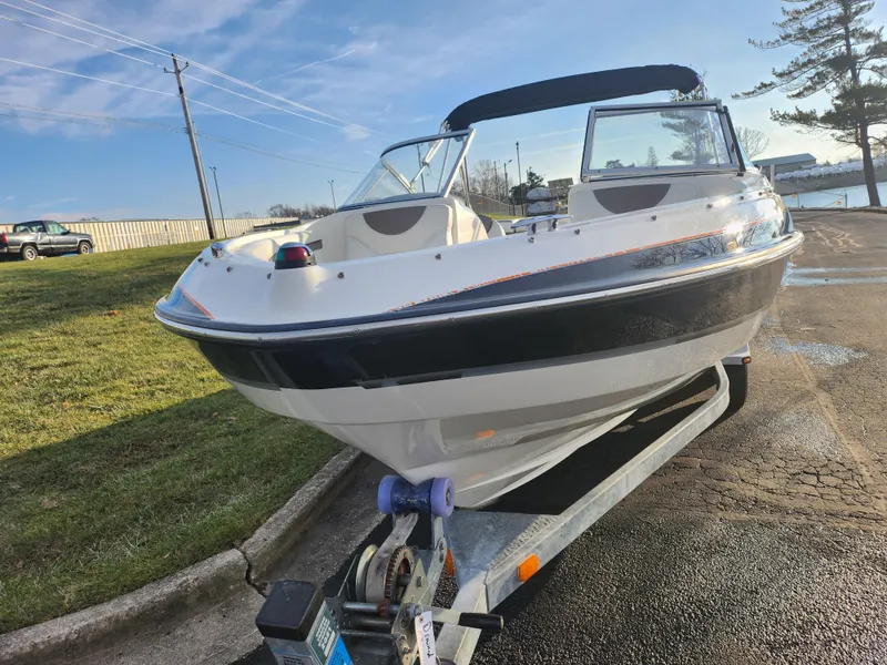 Slide: The Image of 2007 Bayliner 225 boat on trailer in parking lot, sunny day. - 6