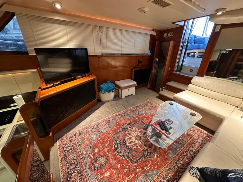 Slide: The Image of Interior of 1989 Viking 44 Motor Yacht with TV, sofa, and decorative rug. - 14