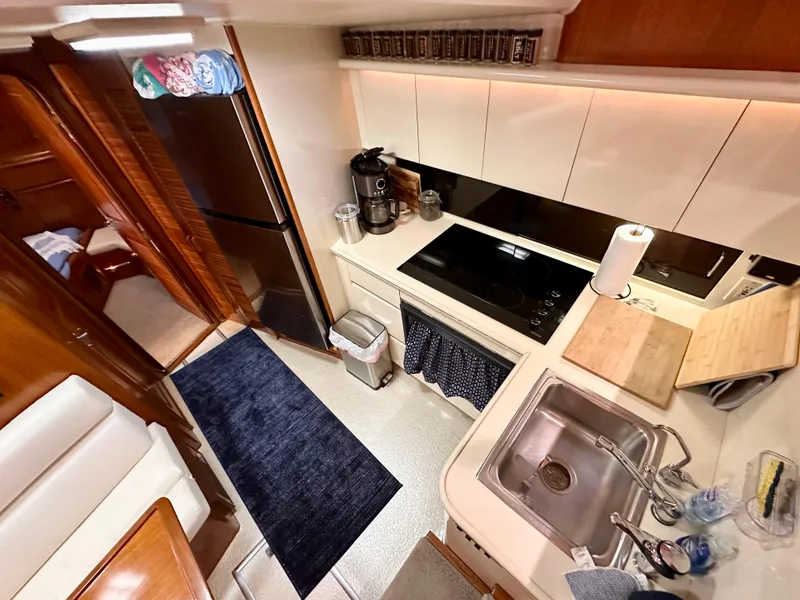 Slide: The Image of 1989 Viking 44 Motor Yacht kitchen with modern appliances and wooden cabinetry. - 17