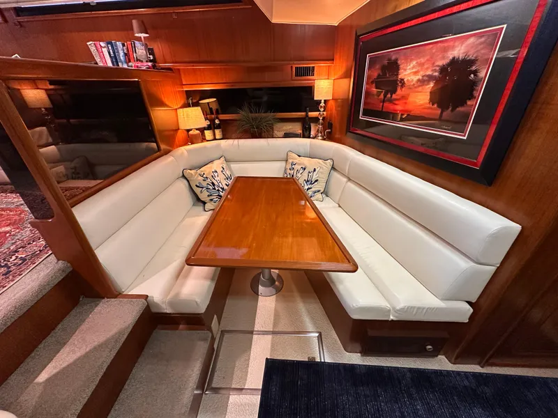 Slide: The Image of Luxurious interior of 1989 Viking 44 Motor Yacht with elegant dining area and sunset artwork. - 18