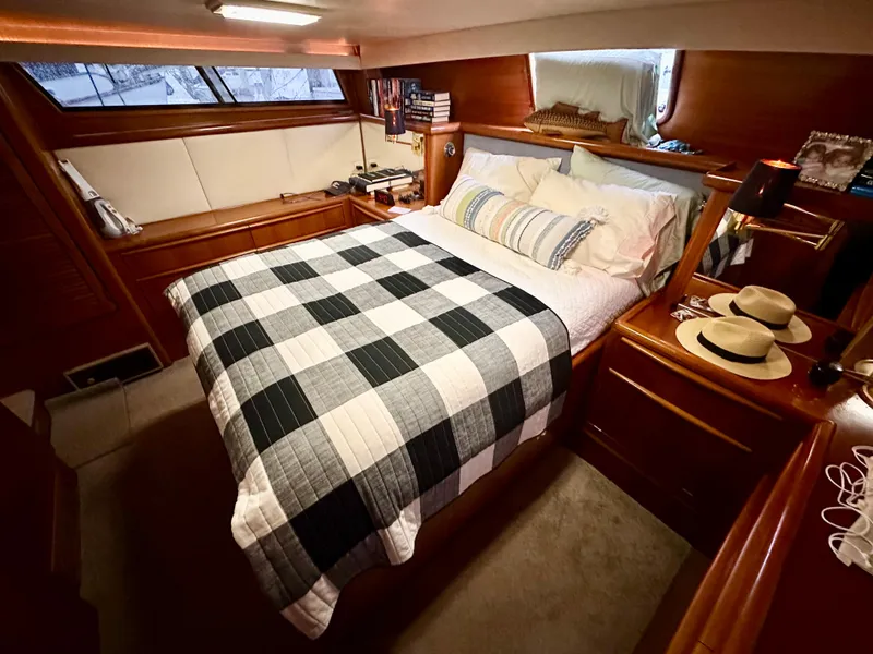 Slide: The Image of Cozy bedroom in 1989 Viking 44 Motor Yacht with plaid bedding and wooden accents. - 25