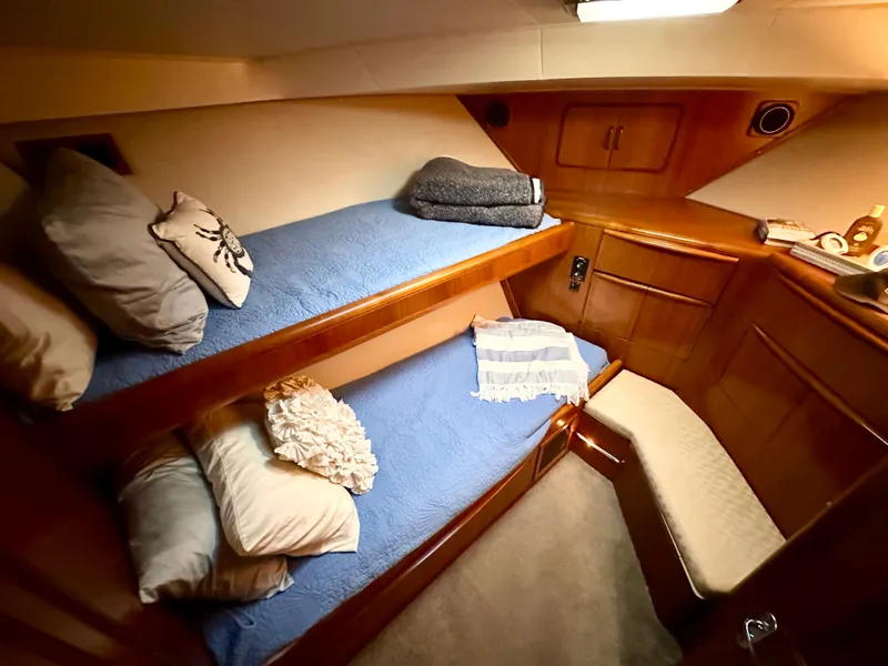 Slide: The Image of Cozy cabin interior of 1989 Viking 44 Motor Yacht with bunk beds and wooden finish. - 29