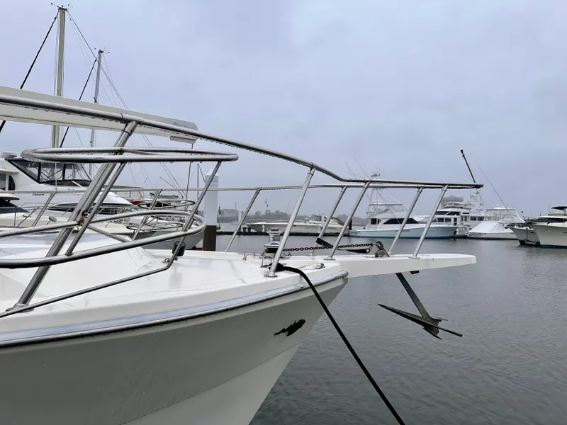 Slide: The Image of 1989 Viking 44 Motor Yacht docked in a marina on a cloudy day. - 3