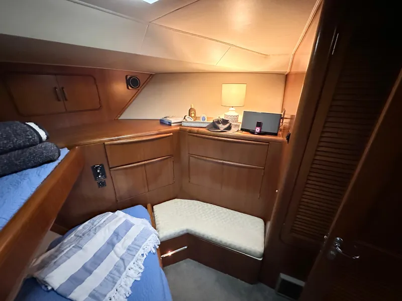 Slide: The Image of 1989 Viking 44 Motor Yacht cabin with cozy seating, wooden cabinetry, and soft lighting. - 30