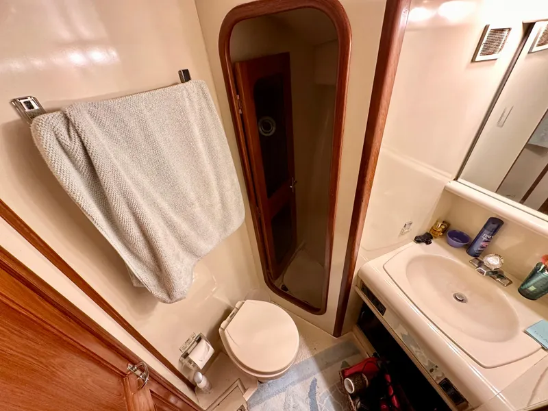 Slide: The Image of Bathroom interior of 1989 Viking 44 Motor Yacht with sink, toilet, and shower. - 31
