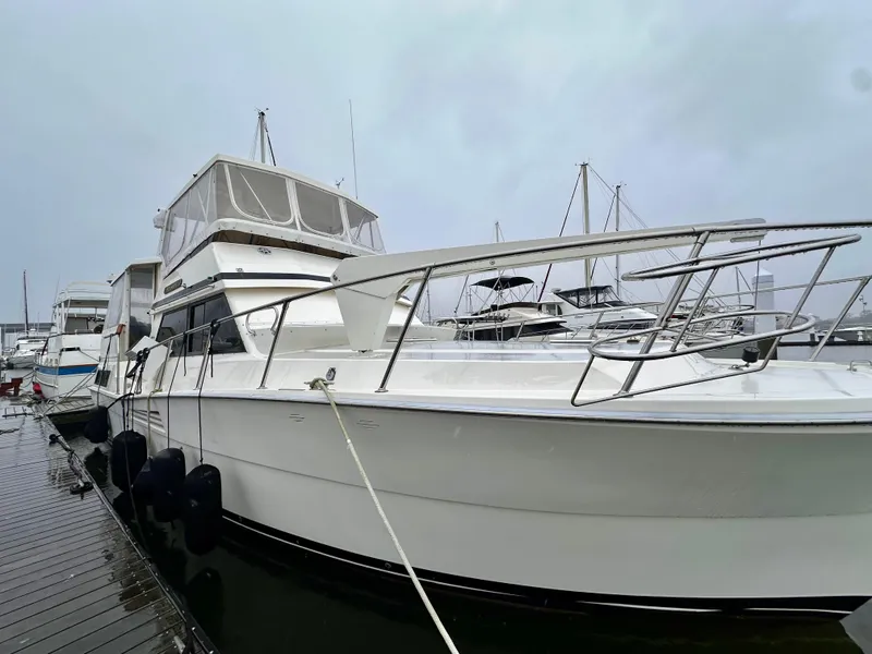 Slide: The Image of 1989 Viking 44 Motor Yacht docked at marina on a cloudy day. - 4