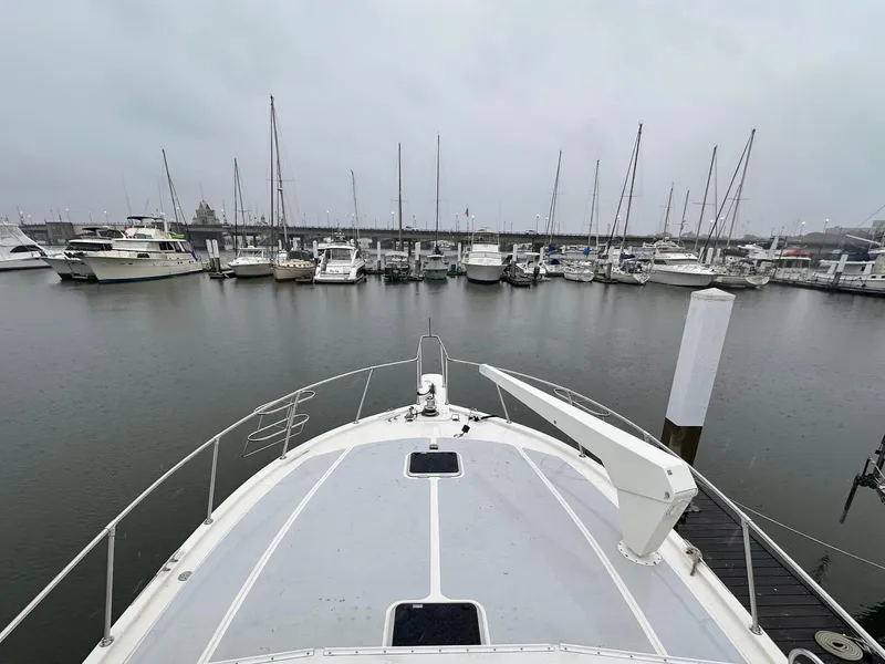Slide: The Image of Bow view of 1989 Viking 44 Motor Yacht docked in a marina. - 5