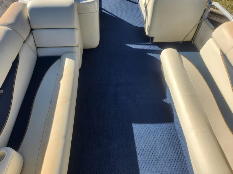 Slide: The Image of Interior of a 2005 Odyssey 522C boat with beige seating and blue carpet. - 10