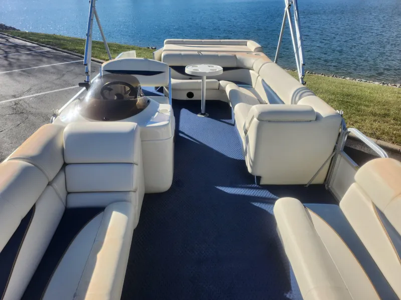 Slide: The Image of 2005 Odyssey 522C pontoon boat with spacious seating and lake view. - 11