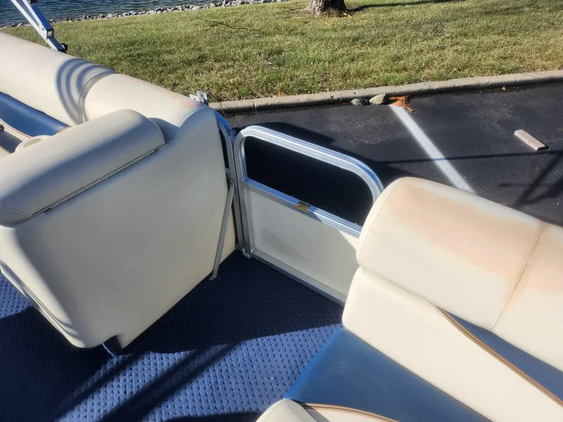 Slide: The Image of 2005 Odyssey 522C boat interior with beige seating and blue carpet. - 12