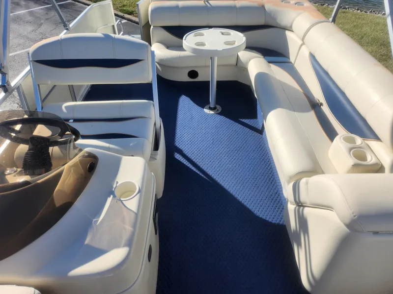 Slide: The Image of 2005 Odyssey 522C boat interior with beige seating and blue carpet. - 13