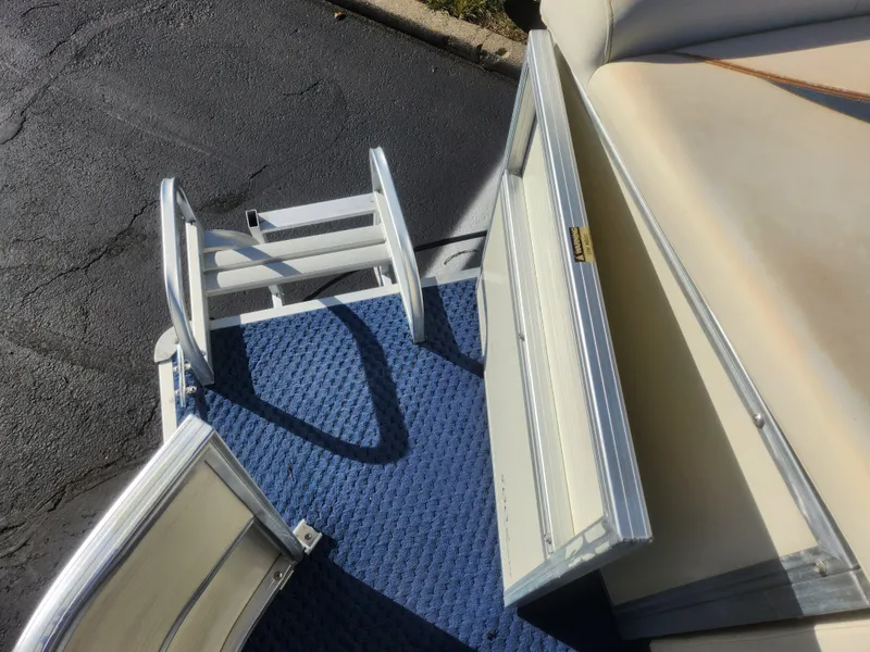 Slide: The Image of 2005 Odyssey 522C boat with blue carpet and foldable ladder. - 16