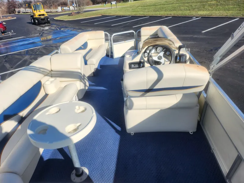 Slide: The Image of 2005 Odyssey 522C pontoon boat interior with seating and steering wheel. - 18