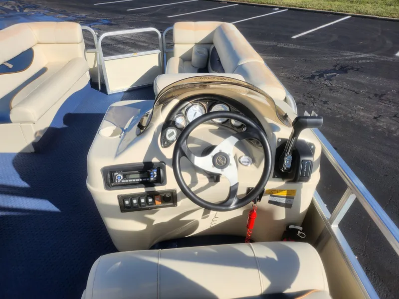 Slide: The Image of 2005 Odyssey 522C boat interior with steering wheel and seating. - 19
