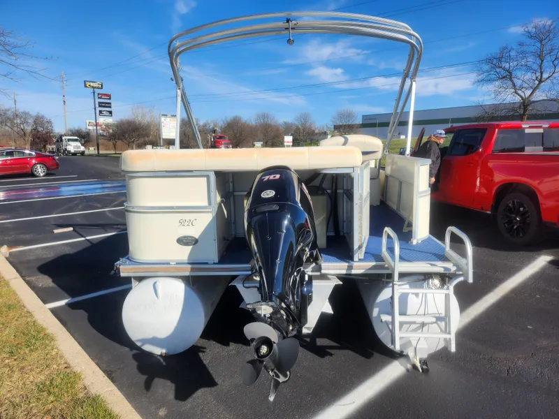 Slide: The Image of 2005 Odyssey 522C pontoon boat with outboard motor in parking lot. - 2