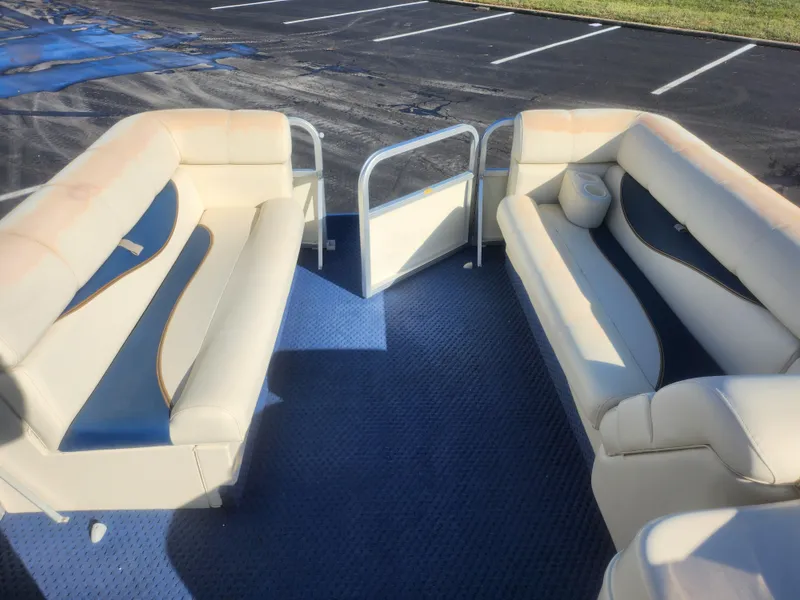 Slide: The Image of 2005 Odyssey 522C boat interior with beige seating and blue carpet. - 21