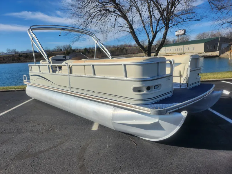 Slide: The Image of 2005 Odyssey 522C pontoon boat parked near a lake on a sunny day. - 8