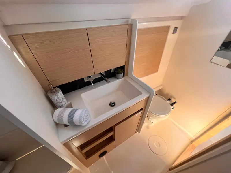 Slide: The Image of Modern bathroom in 2026 Hanse 348 yacht with sink, toilet, and wooden cabinetry. - 17