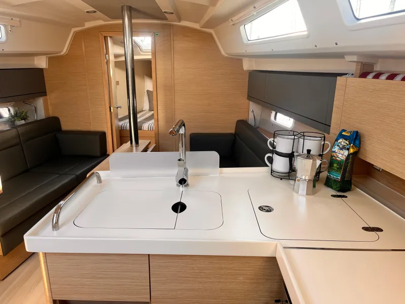 Slide: The Image of Modern interior of 2026 Hanse 348 yacht with sleek kitchen and cozy seating area. - 24
