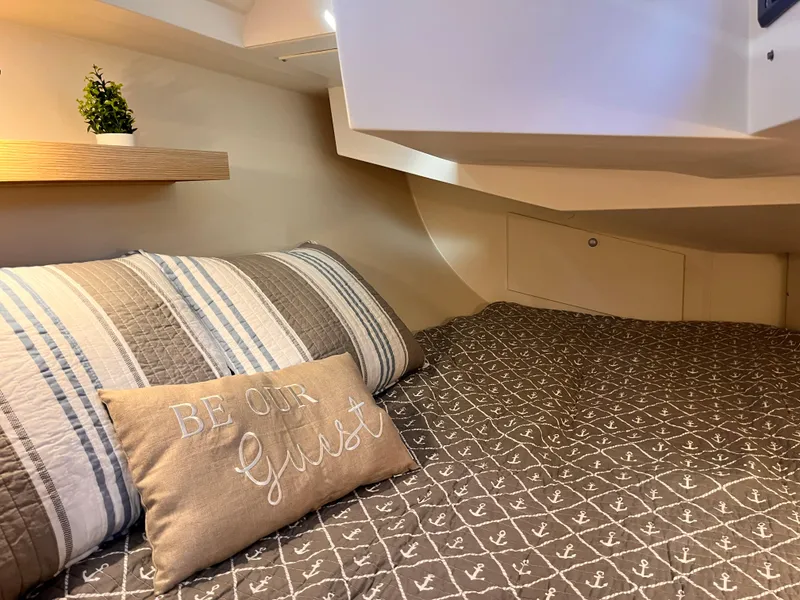 Slide: The Image of Cozy cabin interior of 2026 Hanse 348 yacht with nautical-themed bedding. - 26