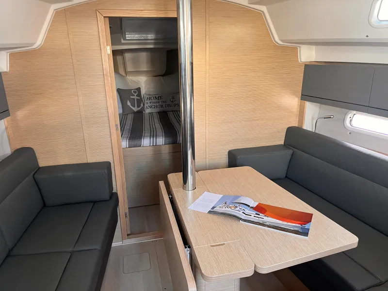 Slide: The Image of 2026 Hanse 348 yacht interior with modern seating and table, featuring a cozy cabin. - 30